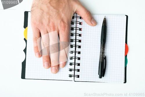 Image of Hand on empty notepad