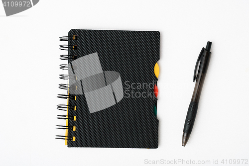 Image of notepad with pen isolated