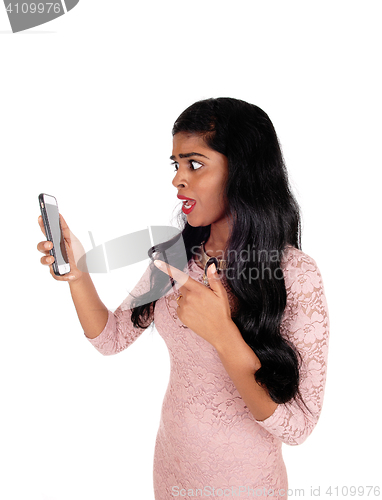 Image of Angry woman looking at phone.