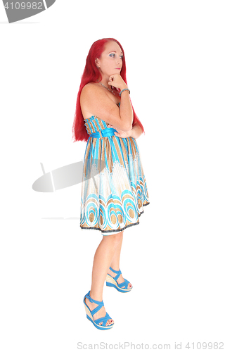 Image of Woman standing with long red hair.