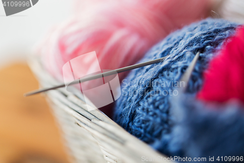 Image of basket with knitting needles and balls of yarn