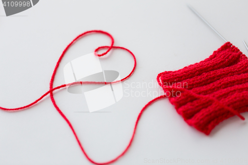 Image of knitting needles and thread in heart shape