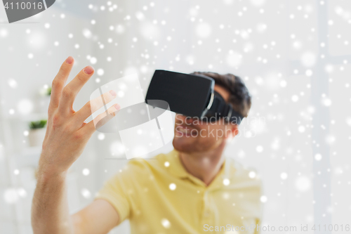 Image of young man in virtual reality headset or 3d glasses