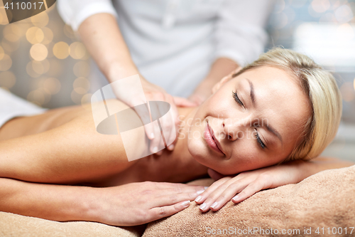 Image of close up of woman lying and having massage in spa