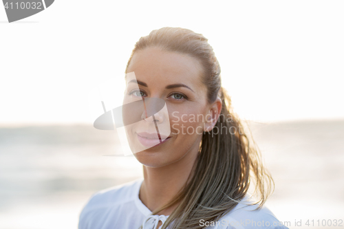 Image of happy young woman face on beach