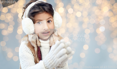 Image of happy little girl wearing earmuffs