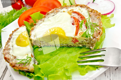 Image of Tartlet meat with egg cut on light board