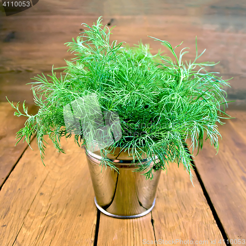 Image of Dill in metal bucket on wooden board