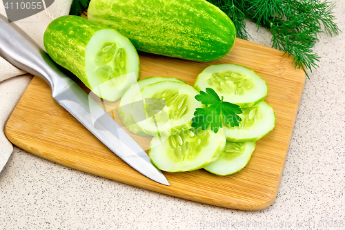 Image of Cucumber with parsley on granite table