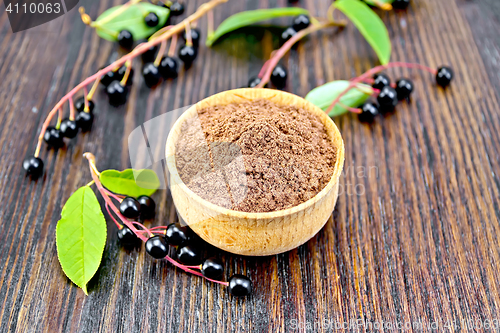 Image of Flour bird cherry in bowl with berries and leaves on board