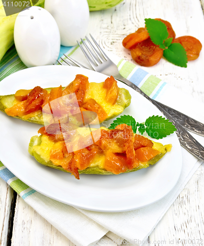 Image of Courgettes in spicy sauce with dried apricots on light board