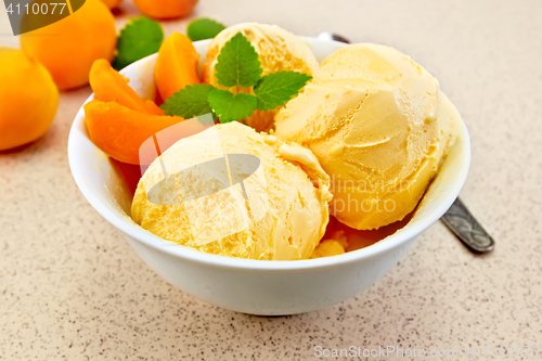 Image of Ice cream apricot in white bowl on table