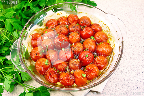 Image of Tomatoes baked in glass pan on table
