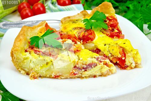 Image of Flan with tomato and zucchini in plate on light board