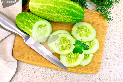 Image of Cucumber with parsley on table top