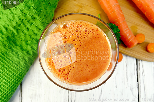 Image of Juice carrot with vegetables and napkin on board top