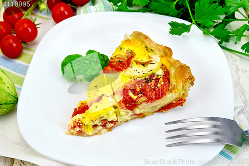 Image of Flan with tomato and zucchini on board