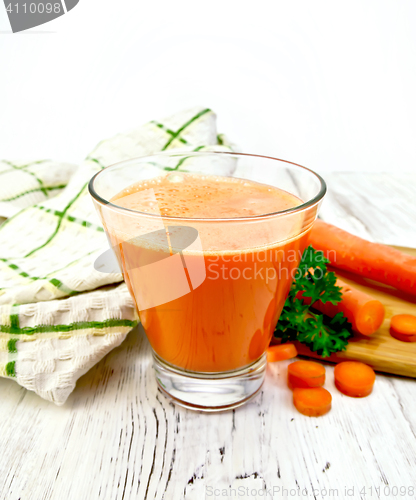 Image of Juice carrot with vegetables and napkin on light board