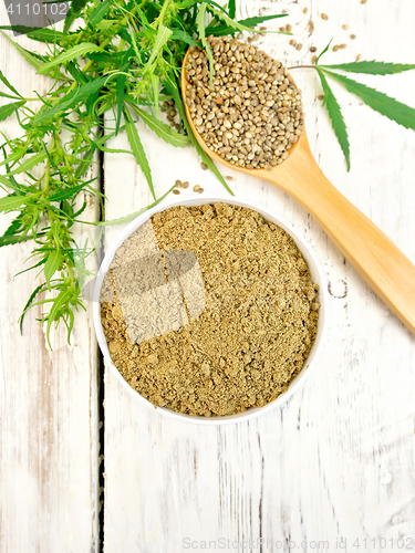 Image of Flour hemp in bowl with spoon and leaf on board top