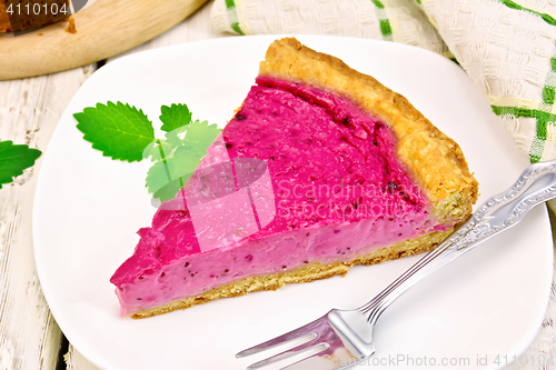 Image of Pie of black currants with mint in plate on board