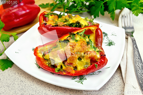 Image of Pepper stuffed with sausage and cheese in plate on table