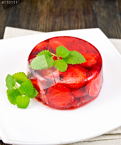 Image of Jelly strawberry with mint on napkin and dark board