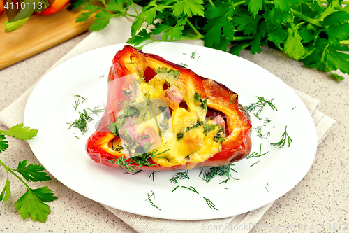 Image of Pepper stuffed with sausage and cheese in plate