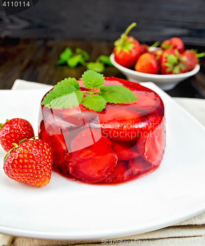 Image of Jelly strawberry with mint and berries on dark board