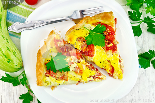 Image of Flan with tomato and zucchini on light board top