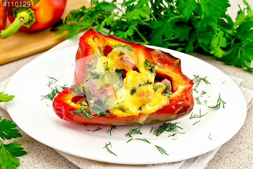 Image of Pepper stuffed with sausage and cheese in plate on stone table