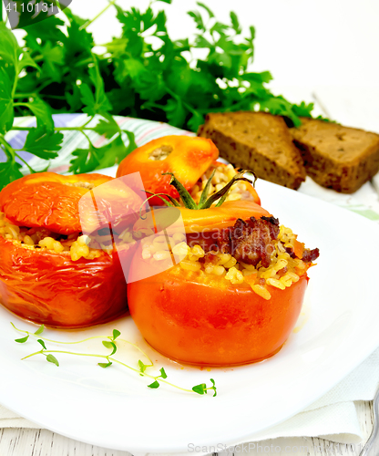 Image of Tomatoes stuffed with bulgur in plate on light board