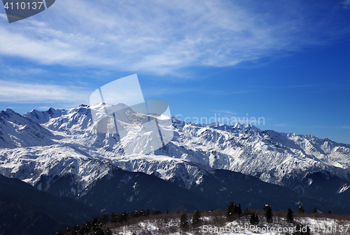 Image of Sunlight snow mountains and cloudy sky in wind winter day