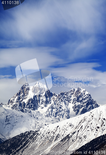 Image of Mounts Ushba and Chatyn and blue sky with clouds in winter wind 