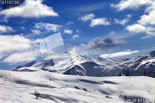 Image of Ski slope and beautiful sky with clouds in sunny evening