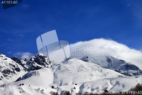 Image of Mountains in clouds and off-piste slope in winter