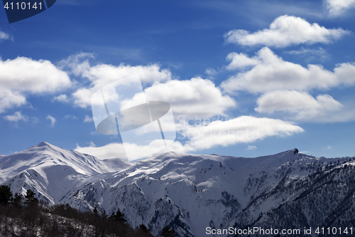 Image of Sunlight snow mountains and blue sky with clouds