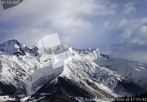 Image of Snow winter mountain and gray sky in evening