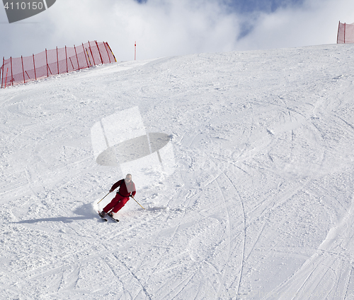 Image of Skier on ski slope at sun day