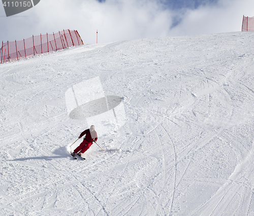 Image of Skier on ski slope at sun day