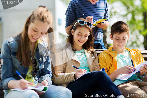 Image of group of students with notebooks at school yard