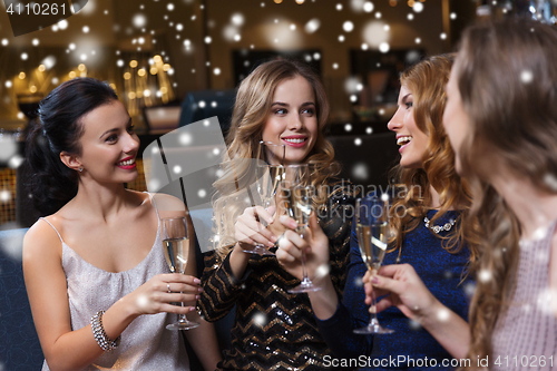 Image of happy women with champagne glasses at night club