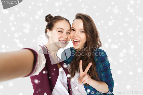 Image of happy friends taking selfie and showing peace