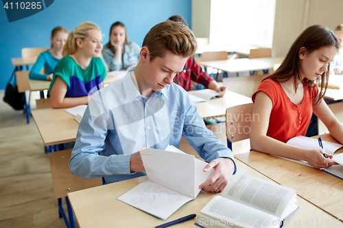 Image of group of students with books at school lesson