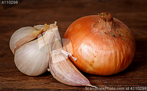 Image of Onion and garlic on wooden table