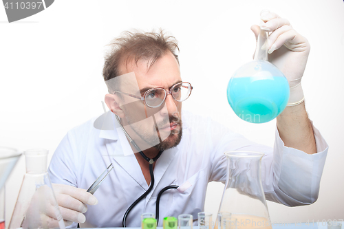 Image of Mad chemist in the lab doing reaction