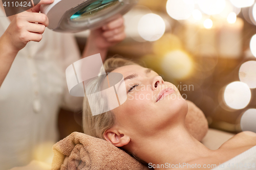 Image of close up of young woman lying in spa