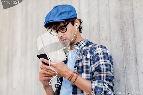Image of man with earphones and smartphone listening music