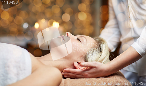 Image of close up of woman having face massage in spa