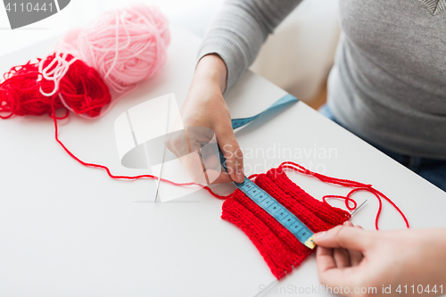 Image of woman with knitting, needles and measuring tape