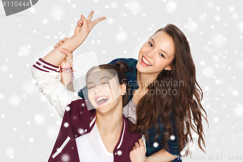 Image of happy pretty teenage girls showing peace hand sign